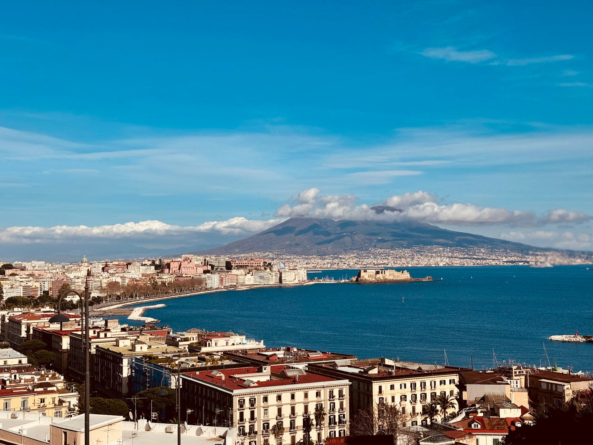 grafi-jeremiah-I1MBKpoC61k-unsplash A large body of water surrounded by buildings. The Volcano of Vesuvius. Naples, Italy. Photo by Grafi Jeremiah on Unsplash