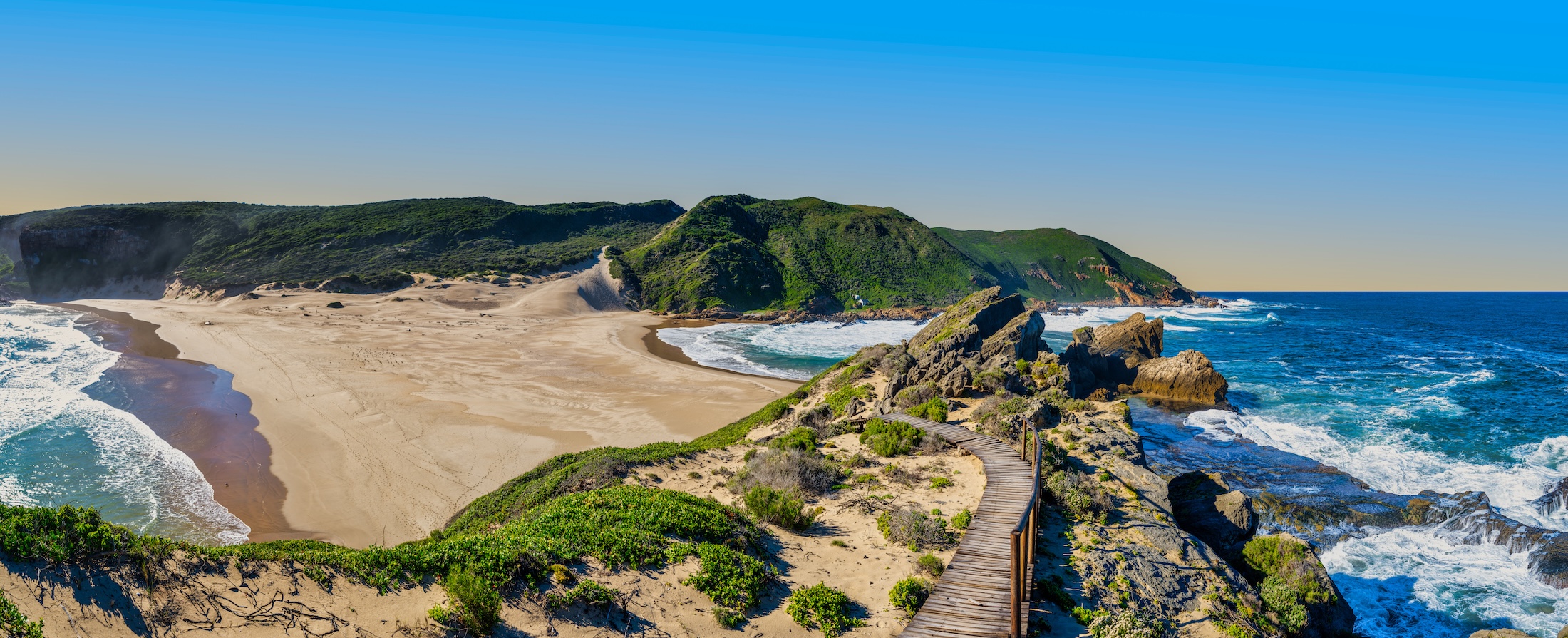 The stunning point of Robberg Peninsula, where vibrant turquoise waters flank both sides of the land, creating an island-like vista, Plettenberg Bay, South Africa