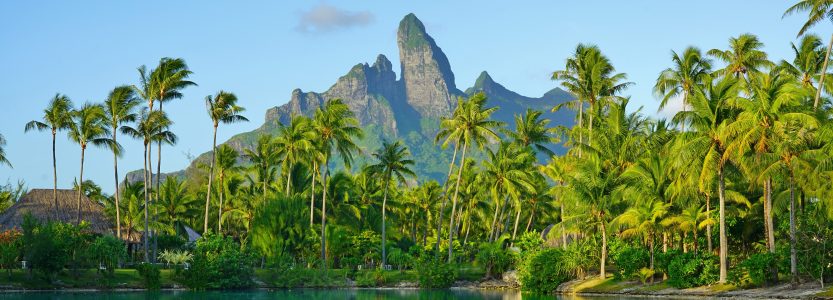 View of the Mont Otemanu mountain reflecting in water at sunset in Bora Bora, French Polynesia, South Pacific