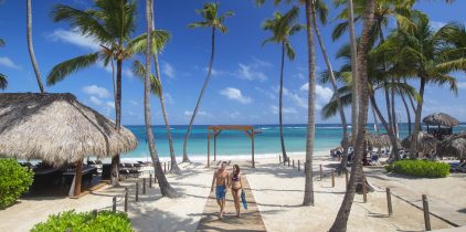 couple walking on beach path at resort